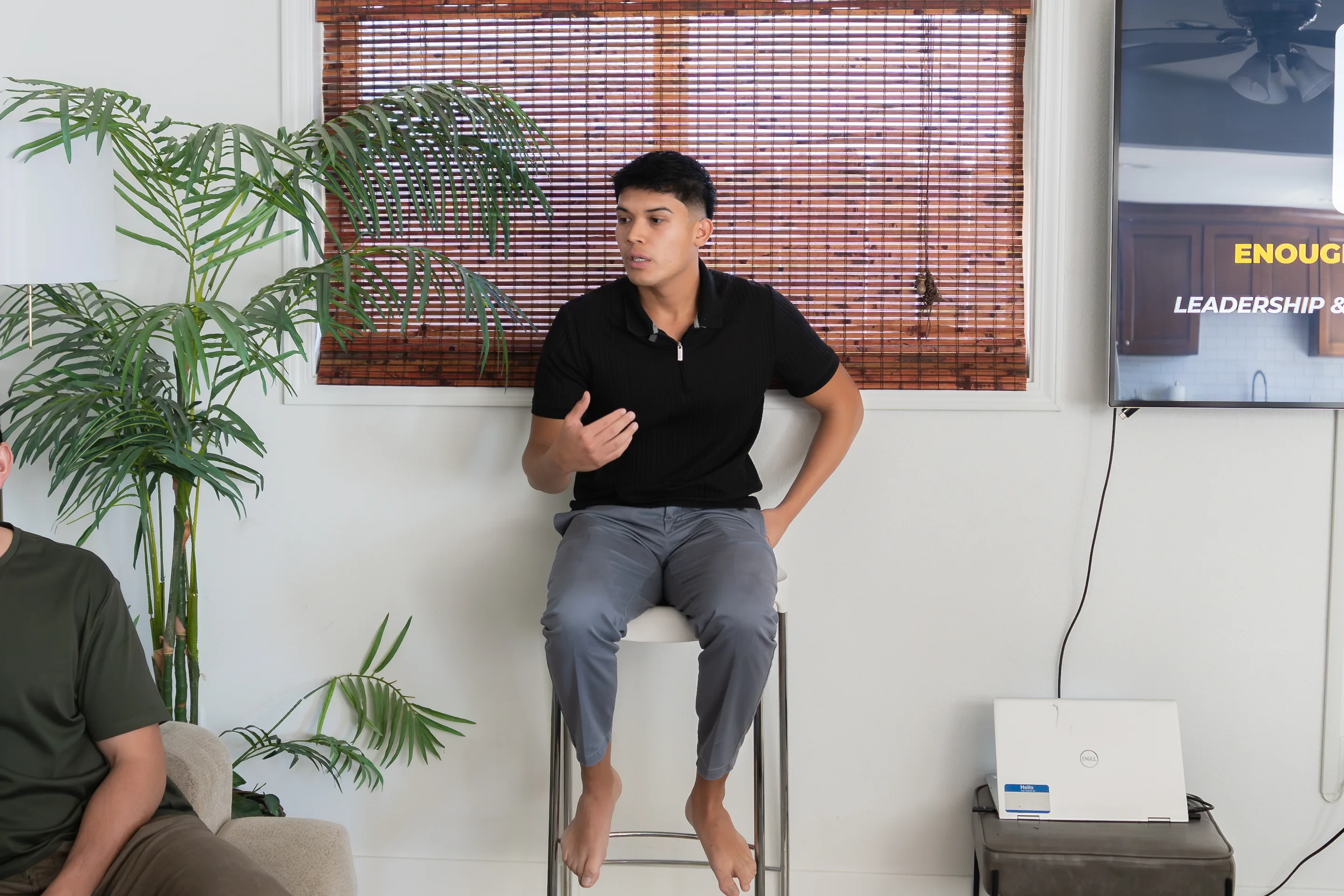 Eliam teaching a leadership session from a stool